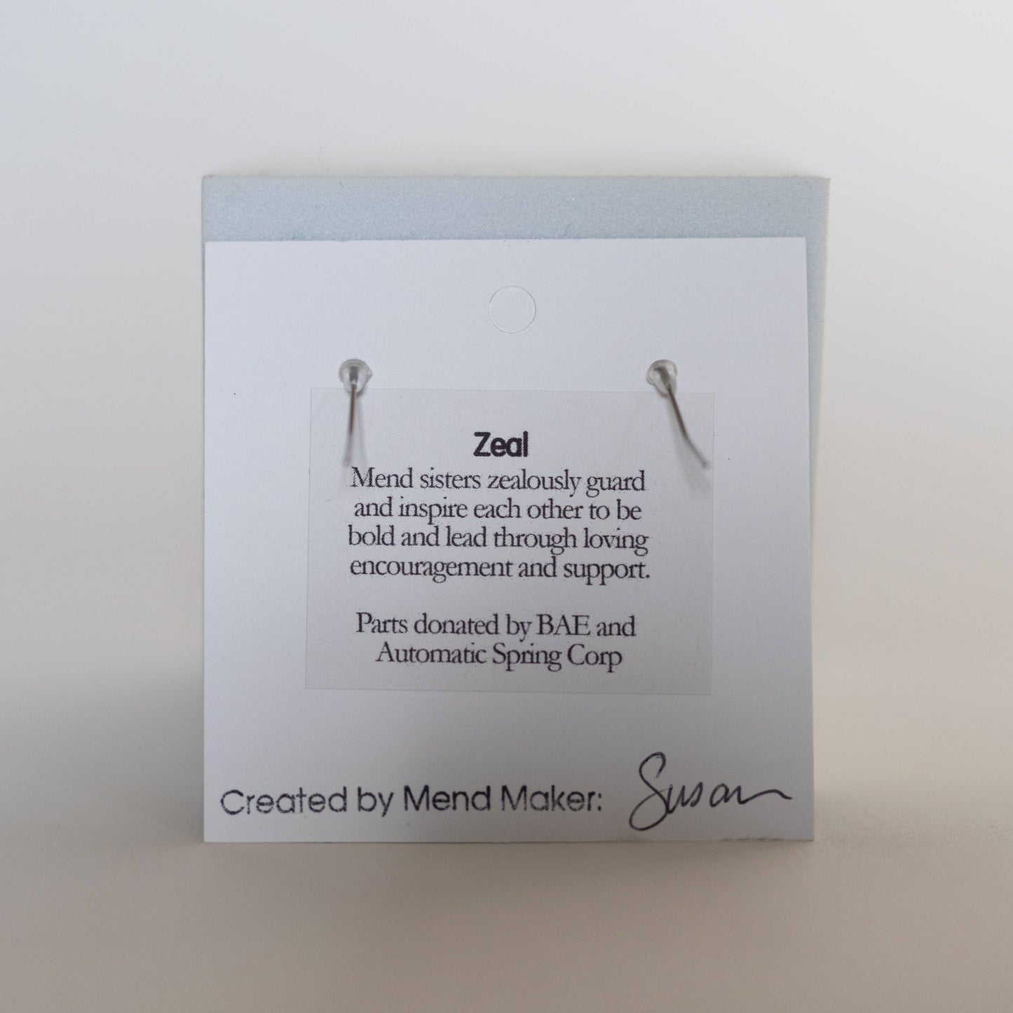 Earrings by Mend on the Move. Jewelry created from auto parts by abuse survivors in Detroit, Michigan.