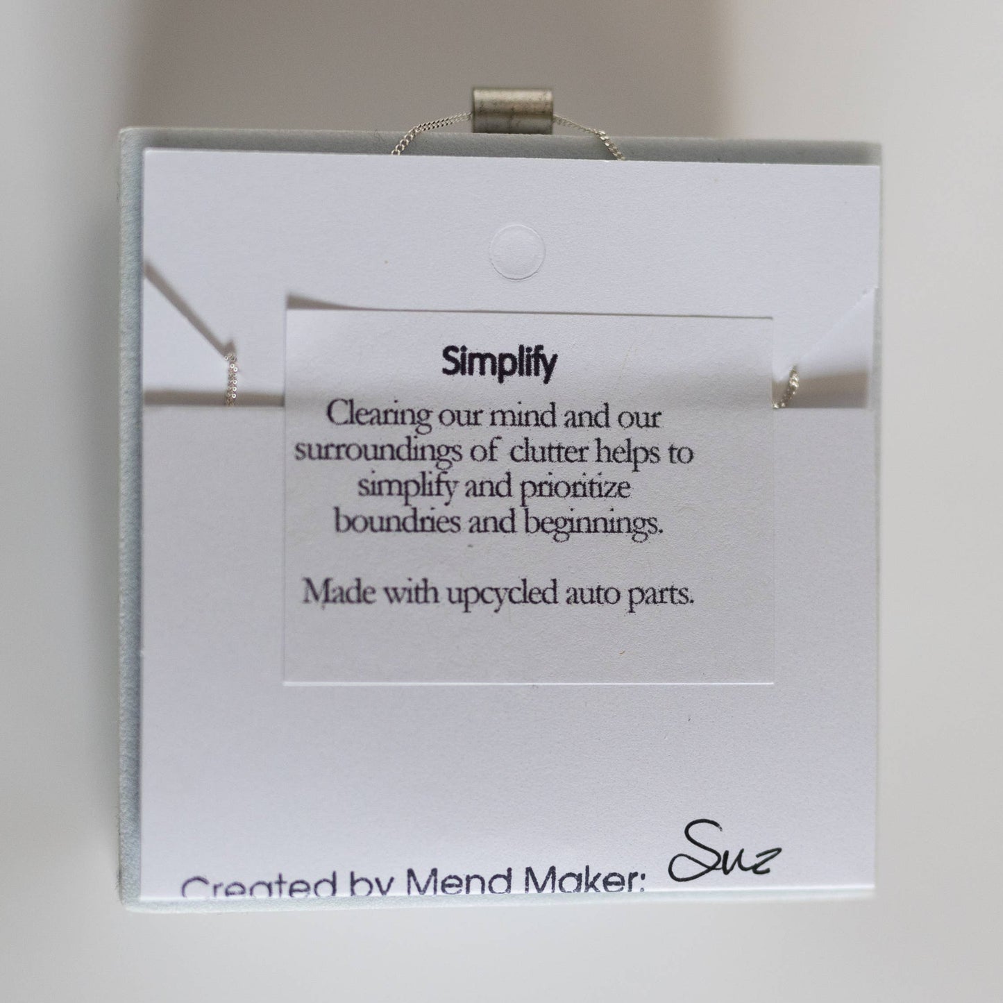 Necklace by Mend on the Move.Jewelry created from auto parts by abuse survivors in Detroit, Michigan.