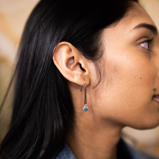 Earrings by Mend on the Move. Jewelry created from auto parts by abuse survivors in Detroit, Michigan.