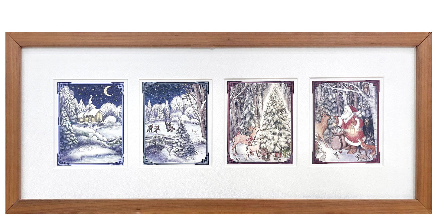 A framed artwork titled 'Woodland Christmas' displaying a quartet of woodland-themed illustrations, including a cabin, ice skaters, a Christmas tree, and Santa Claus, set against a white background.