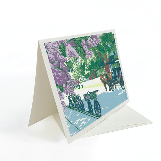 A blank A6 greeting card featuring a block print of lilac flowers on Mackinac Island's Main Street.