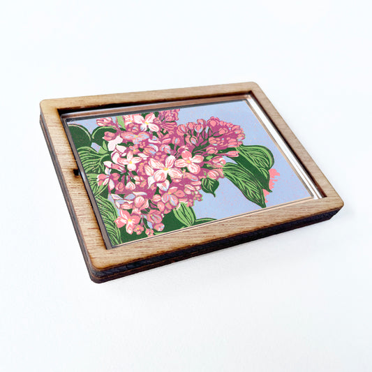 Decorative magnet featuring the block print, "Lilacs," by Peninsula Prints. The magnet has a protective clear coating and wooden frame.