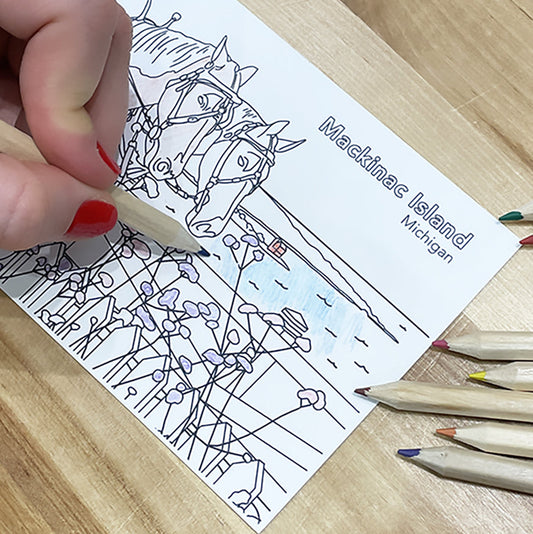 A postcard featuring a horse-drawn carriage on Mackinac Island, Michigan.