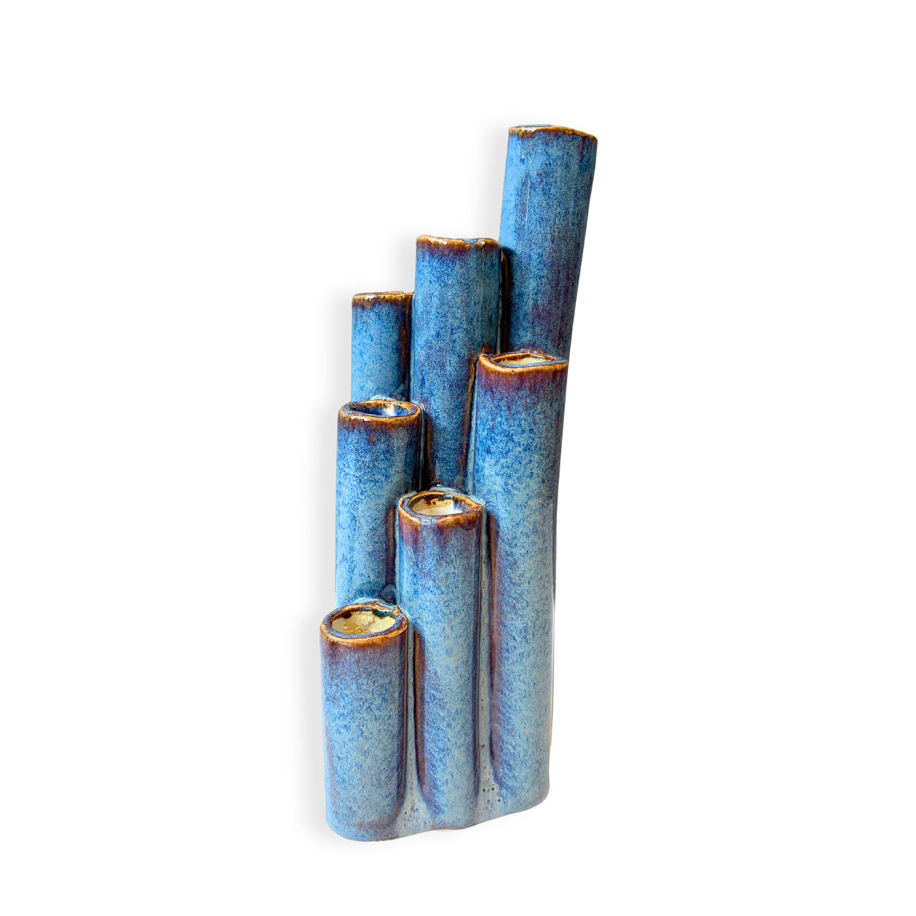 A ceramic wall-mounted decorative sculpture resembling five stacked, widening blue-glazed bamboo or wood tubes with a brown glazed rim, shown against a plain white background.