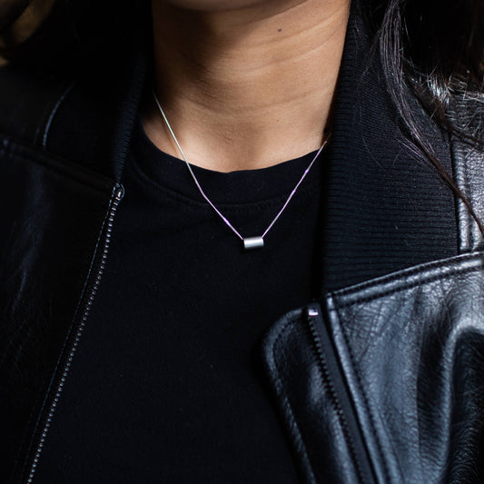 Necklace by Mend on the Move.Jewelry created from auto parts by abuse survivors in Detroit, Michigan.