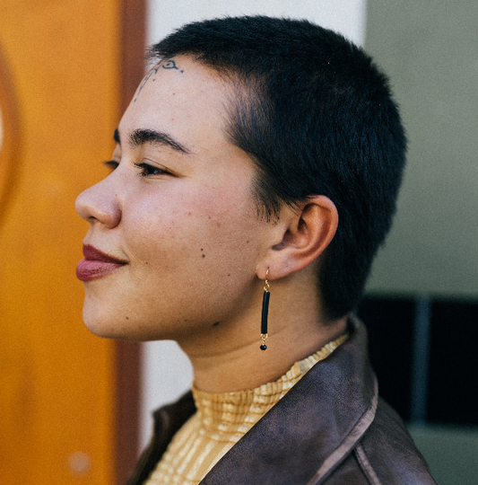 Earrings by Mend on the Move.Jewelry created from auto parts by abuse survivors in Detroit, Michigan.