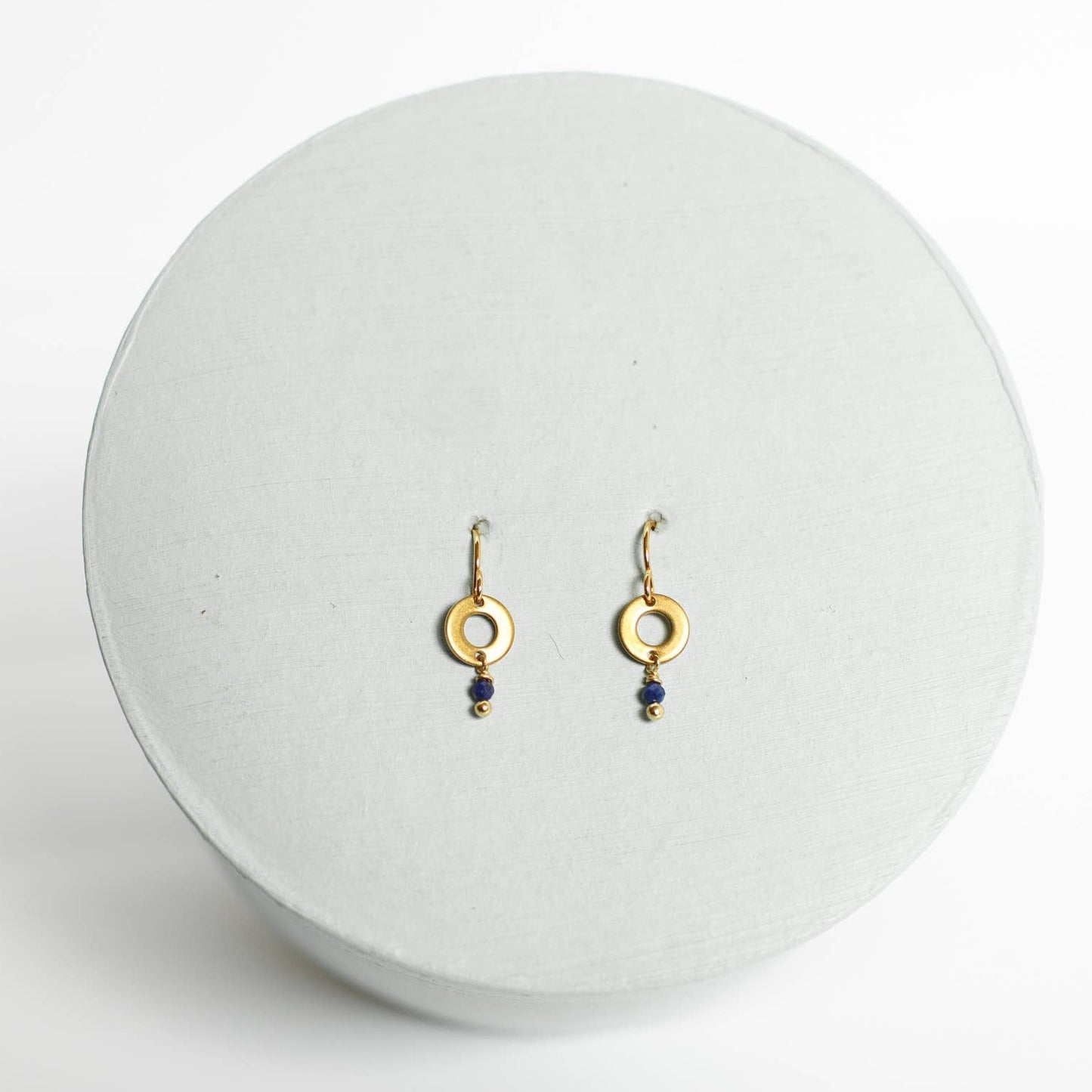 Earrings by Mend on the Move. Jewelry created from auto parts by abuse survivors in Detroit, Michigan.