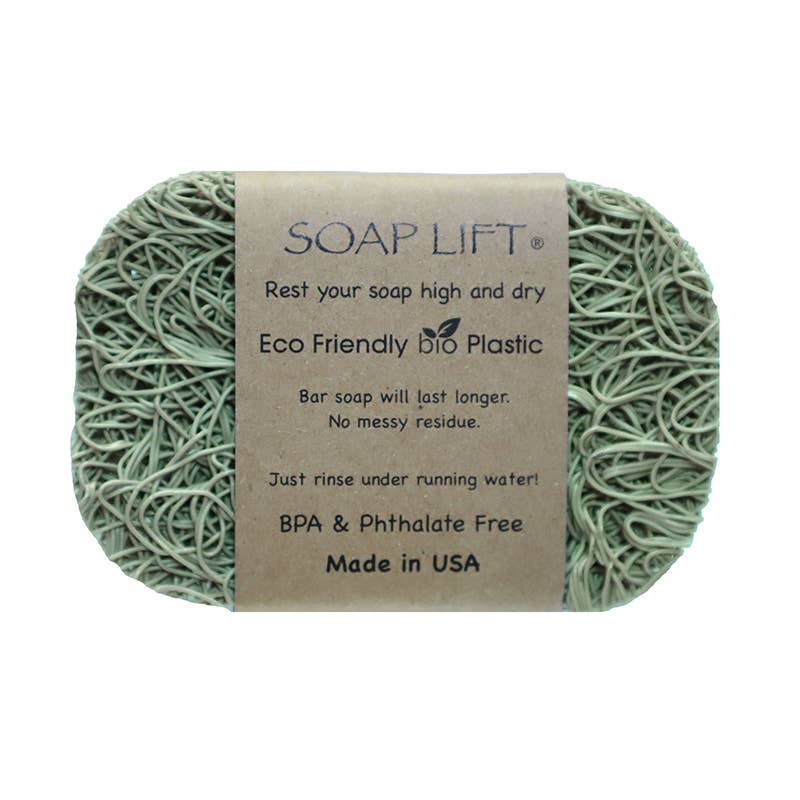 A green Soap Lift soap saver made from bioplastic, displayed with its packaging that states 'Soap Lift', 'Rest your soap high and dry', 'Eco Friendly Bio Plastic', and 'Made in USA'. The product is designed to hold bar soap high and dry, preventing it from standing in water and turning into a mess.