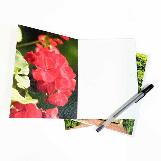 Blank greeting card featuring a photograph of a Mackinac Island cottage gate covered in geranium blooms by Michigan artist Jennifer Wohletz of Mackinac Memories.