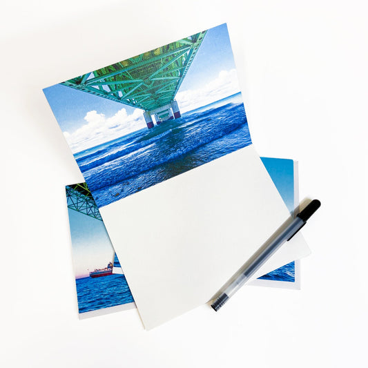 Blank greeting card featuring a photograph of a freighter passing under the Mackinac Bridge by local artist Jennifer Wohletz of Mackinac Memories.