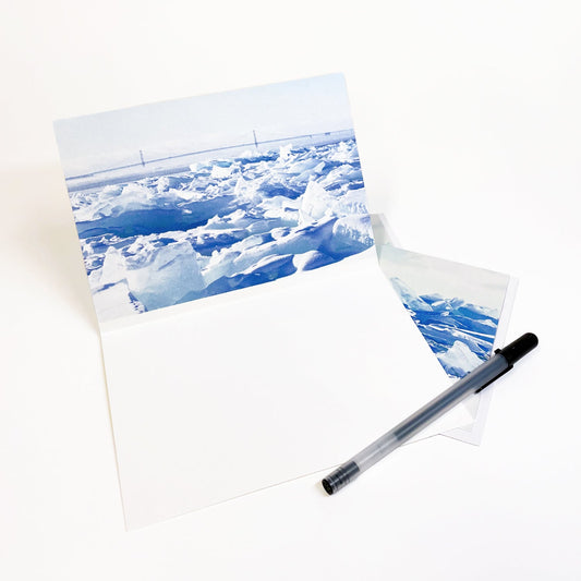 Blank greeting card featuring a photograph featuring a view of the Mackinac Bridge behind a wall of blue ice by local artist Jennifer Wohletz of Mackinac Memories.