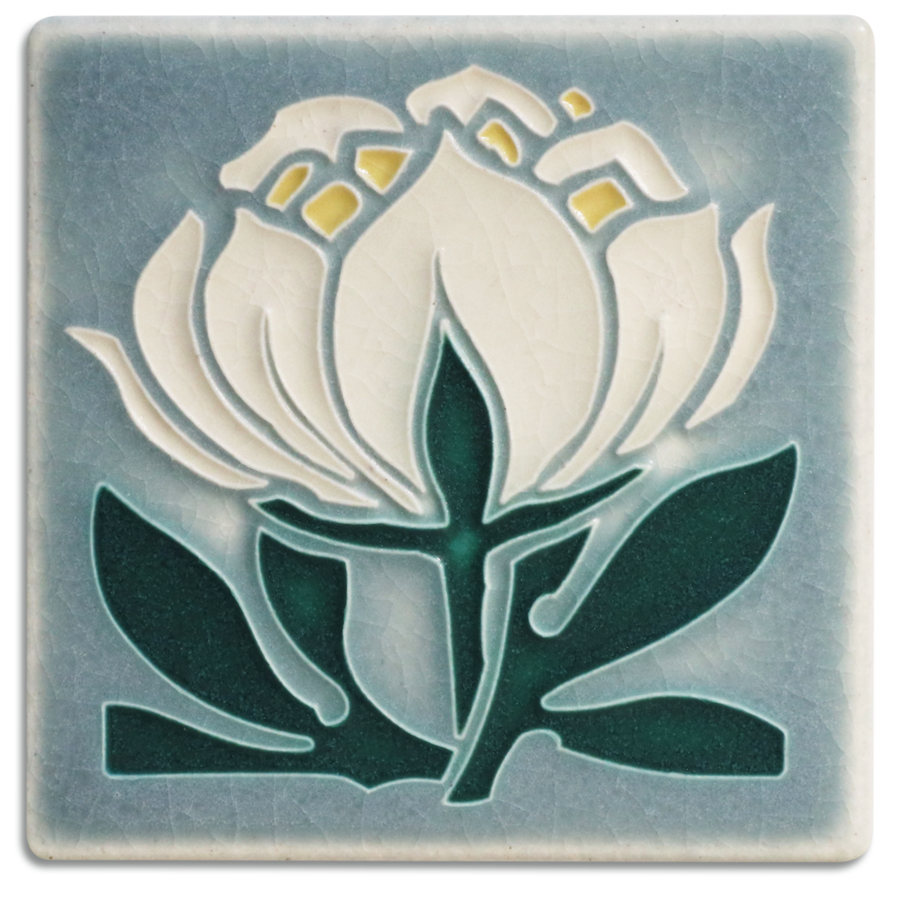 A handmade ceramic art tile featuring a grey and blue peony bloom design by Motawi in Ann Arbor, Michigan.