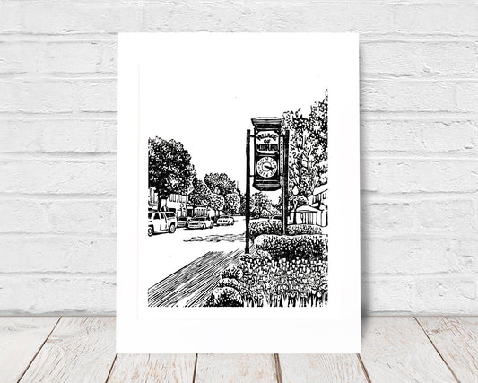 Milford Clock is a one-color linoleum block print depicting Milford, Michigan's Main Street, by Natalia Wohletz of Peninsula Prints.
