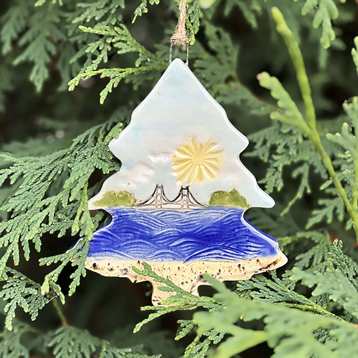 Mackinac Waves Christmas ornament featuring a block print of the Mackinac Bridge by Natalia Wohletz.