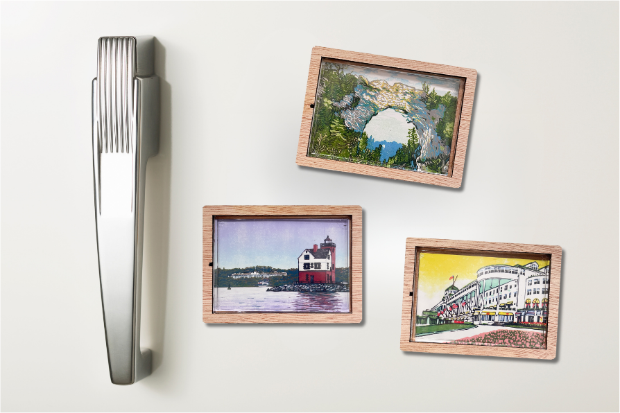 Three of Natalia Wohletz's Peninsula Prints designs as magnets with small wood frame on light gray refrigerator.