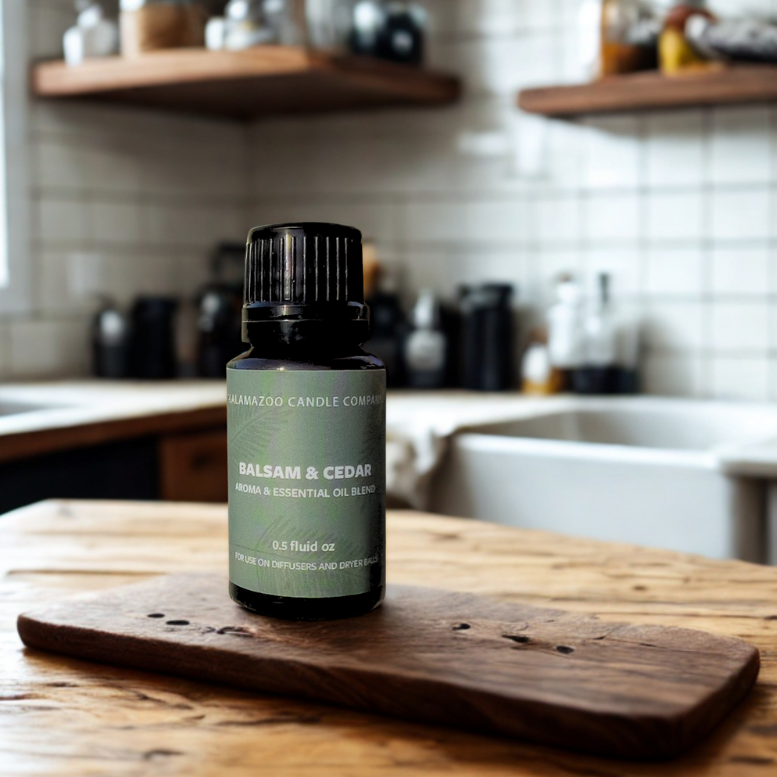 A .5 fluid oz. bottle of 'Balsam & Cedar' aroma & essential oil by Kalamazoo Candle Company.