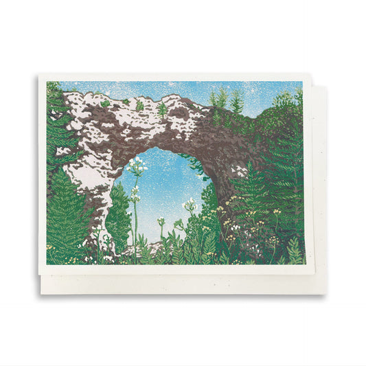 A blank A6 greeting card featuring a block print of Mackinac Island's Arch Rock.