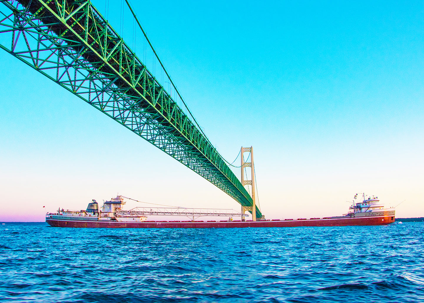 This unique perspective of a freighter traveling beneath the Mackinac Bridge by Jennifer Wohletz of Mackinac Memories evokes a sense of wonder at the bridge's strength and regional importance. &nbsp;The Mighty Mac spans across the Great Lakes to connect Michigan's upper and lower peninsulas. 