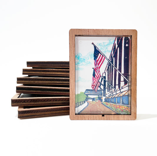 This charming magnet features a solid wood back and clear lens insert surrounded by a stylish wood border.&nbsp; Inspired by the Grand Hotel on Mackinac Island, Michigan.&nbsp; Art by Natalia Wohletz of Peninsula Prints and Main Street Art.