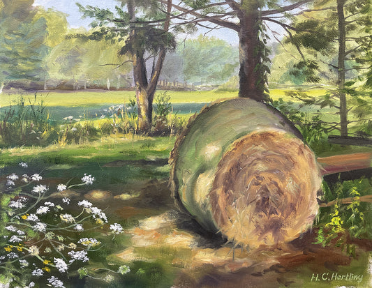 Heiner Hertling’s oil painting delightfully captures farm life with a hay bale resting near the tree line, surrounded by wildflowers and glowing in the gentle evening light.