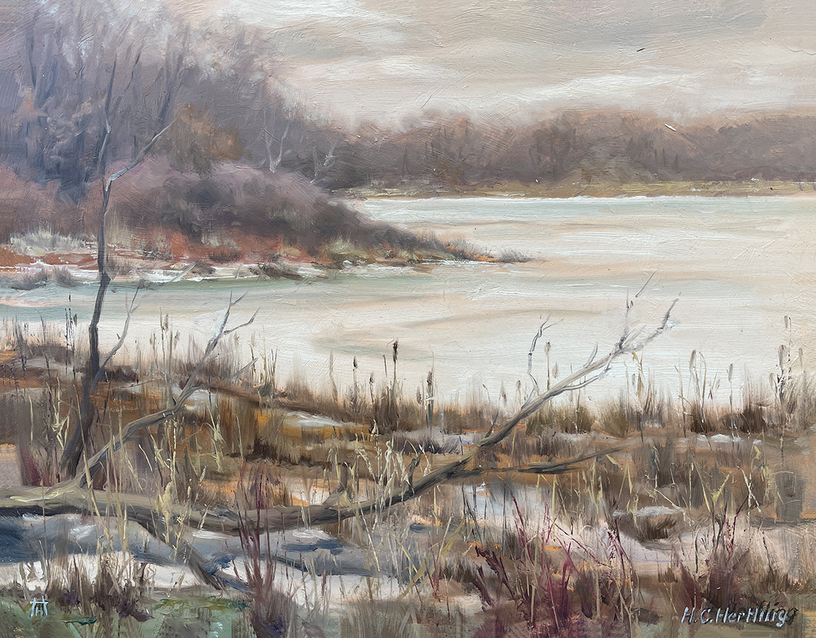 Heiner Hertling’s oil painting captures a winter lakeshore scene, featuring ice on the lake and bare branches reaching out into the chilly air.