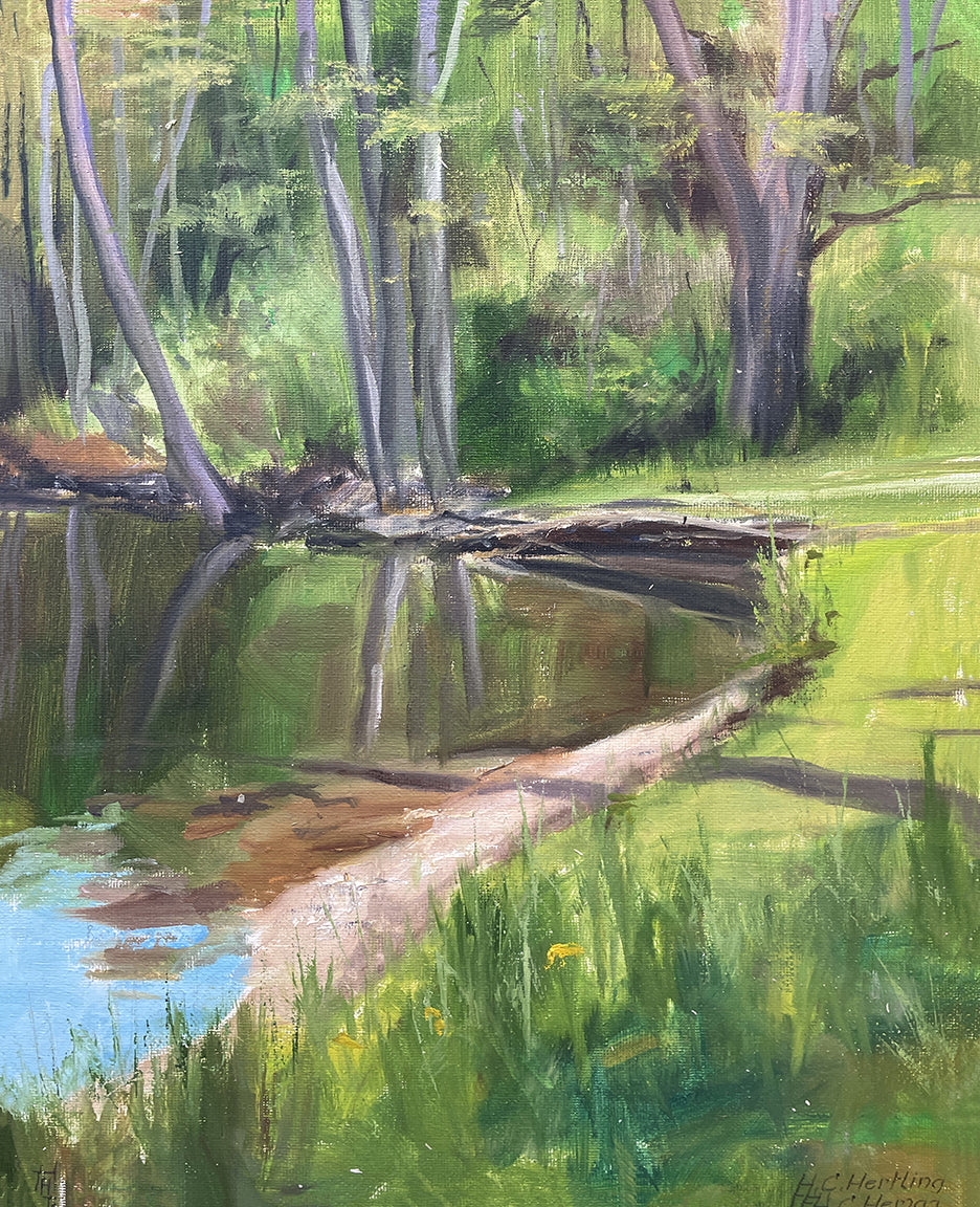 Heiner Hertling’s oil painting captures reflections of trees shimmering softly in the water, surrounded by lush green grass and foliage bathed in gentle light.