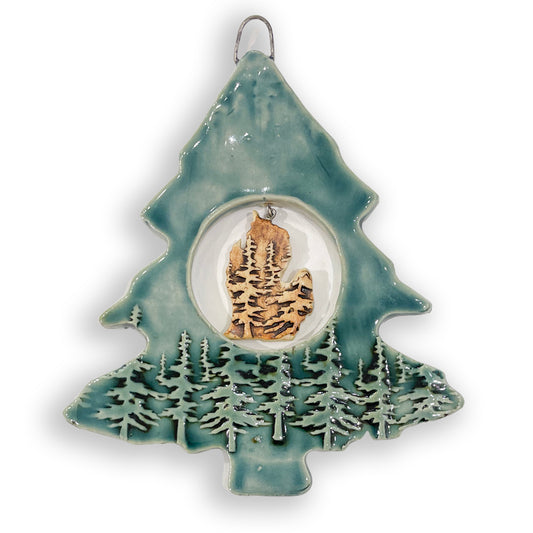 Enhance your holiday decor with a touch of pure Michigan charm! This handcrafted blue and tan tree ornament features a Michigan mitten map in the center, adding a special touch to your Christmas tree. Handcrafted by the ceramic artist Jeanne DeHaan of Milford, Michigan.&nbsp;