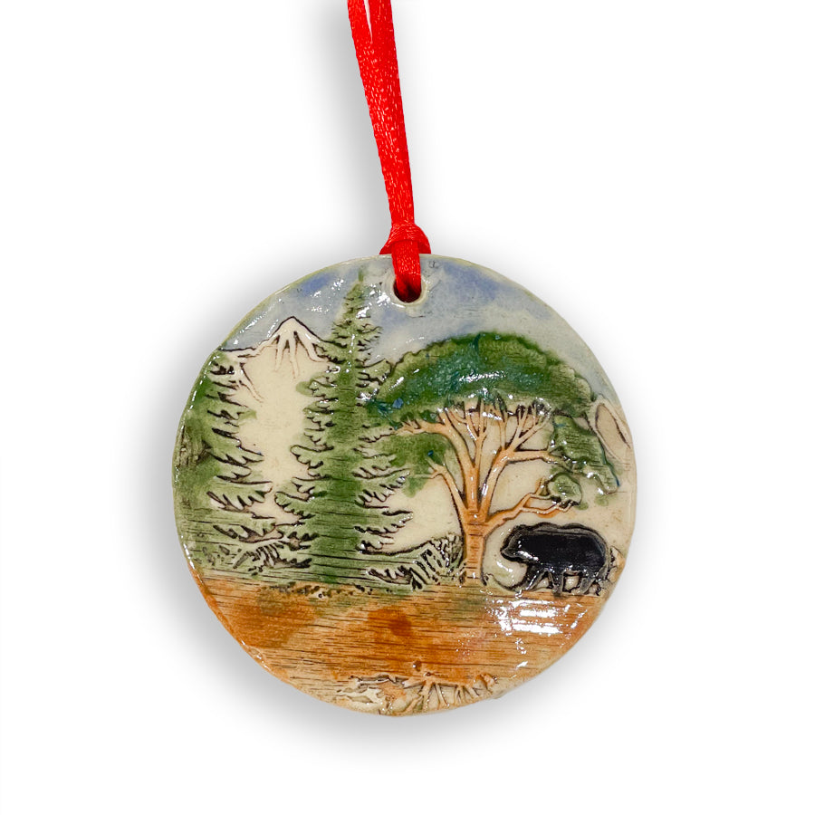 Add a touch of nature to your Christmas tree with these handmade in Michigan ceramic ornaments, featuring nature scenes with a bear, by Jeanne DeHaan.