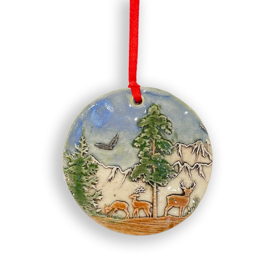 Add a touch of nature to your Christmas tree with these handmade in Michigan ceramic ornaments, featuring nature scenes with a deer by Jeanne DeHaan.