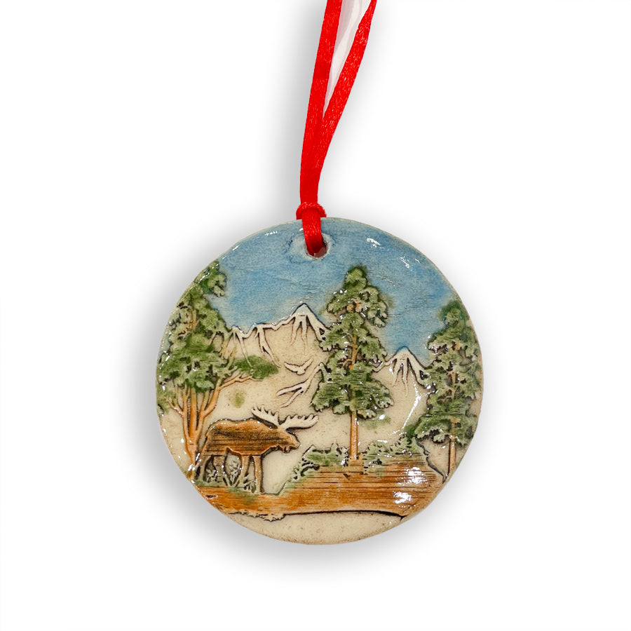 Add a touch of nature to your Christmas tree with these handmade in Michigan ceramic ornaments, featuring nature scenes with a moose by Jeanne DeHaan.