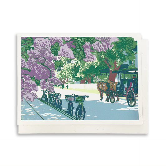 A blank A6 greeting card featuring a block print of lilac flowers on Mackinac Island's Main Street.