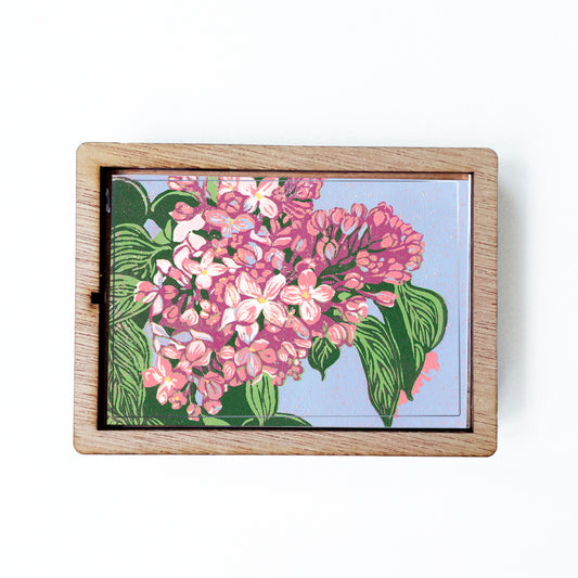 Decorative magnet featuring the block print, "Lilacs," by Peninsula Prints. The magnet has a protective clear coating and wooden frame.