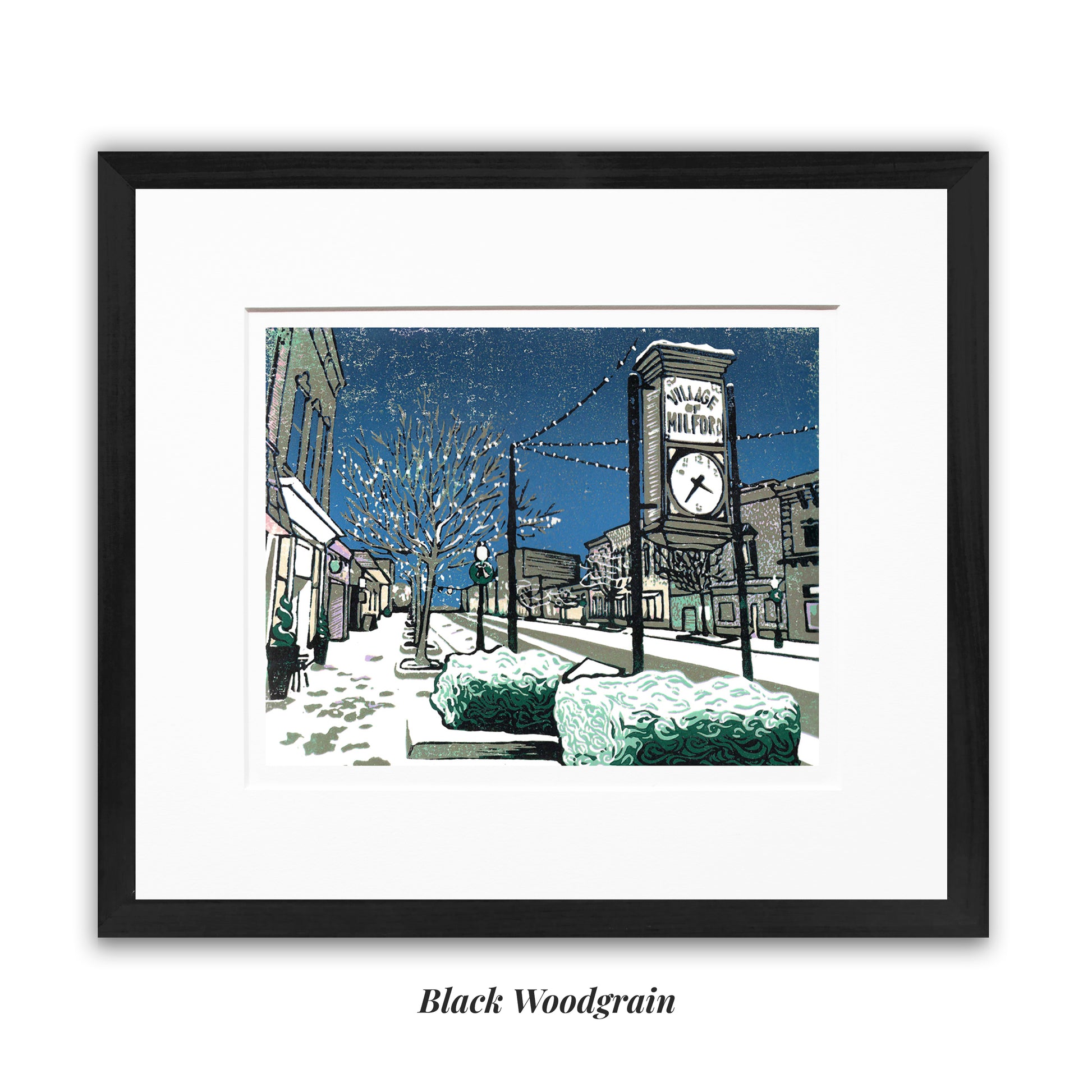 Framed artwork of a snowy street scene with a clock tower, framed in a  black woodgrain frame. "Milford Lights" block print by Peninsula Prints featuring Milford, Michigan's Main Street during Christmastime.