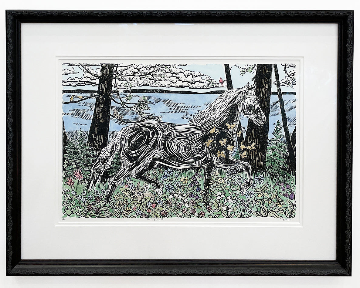 Framed artwork of a horse in a forest setting with a black frame. An original block print by Natalia Wohletz.