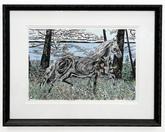 Framed artwork of a horse in a forest setting with a black frame. An original block print by Natalia Wohletz.