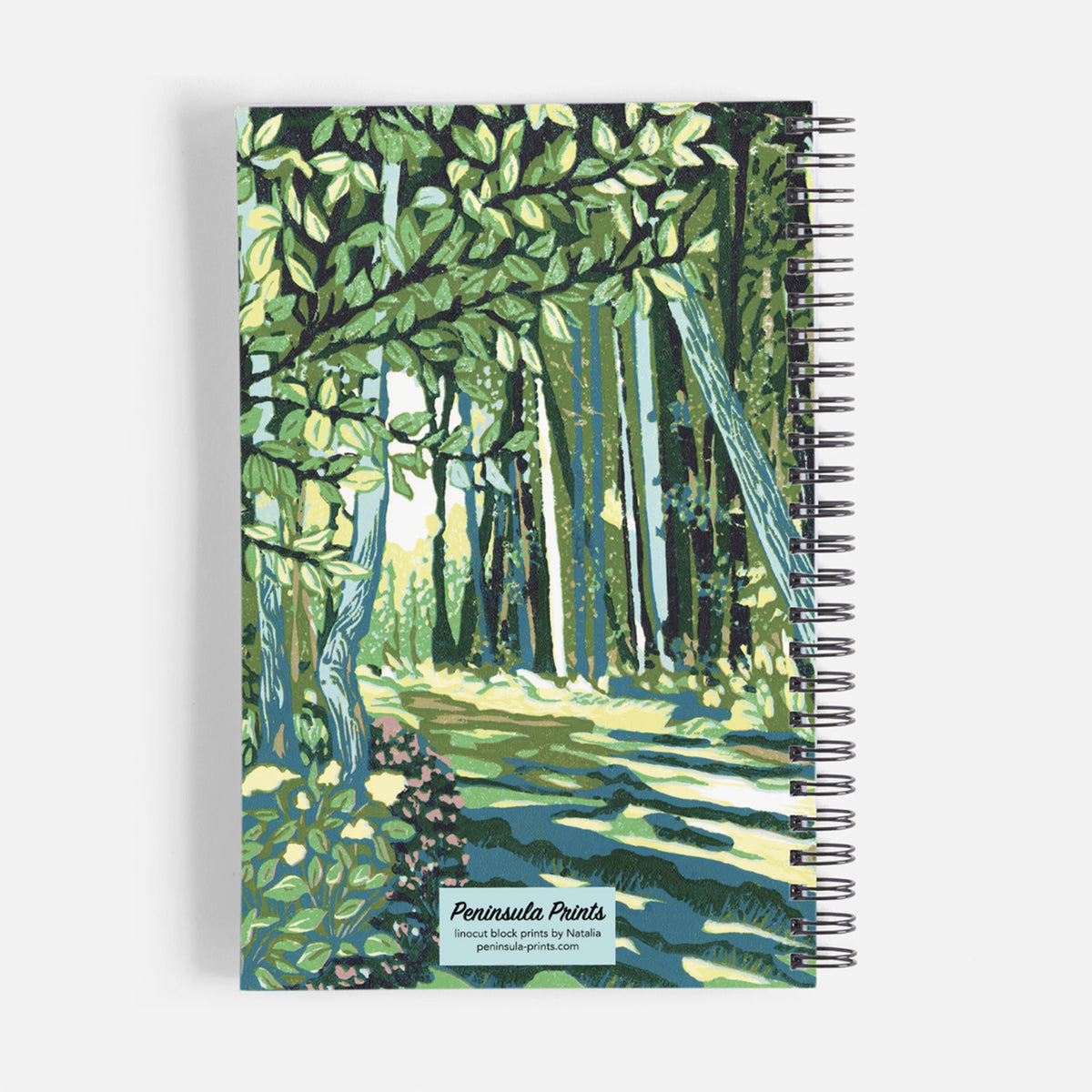Spiral notebook featuring a block print design of a cedar trail by Natalia Wohletz of Peninsula Prints.