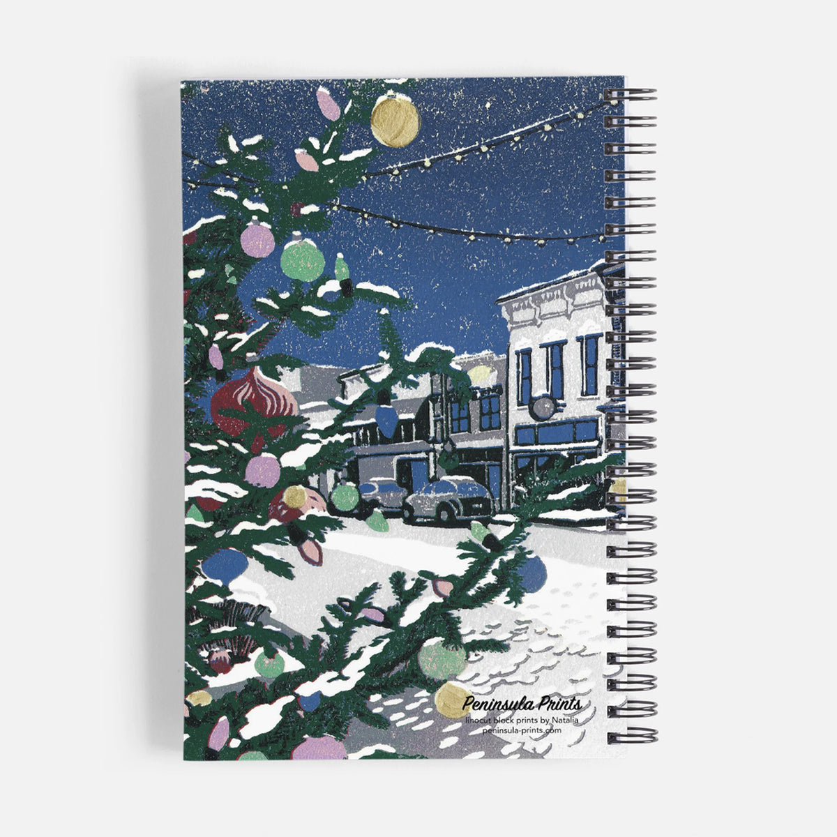 Journal/Notebook - featuring a small town Christmas block print design by Natalia Woheltz of Peninsula Prints on the back cover.