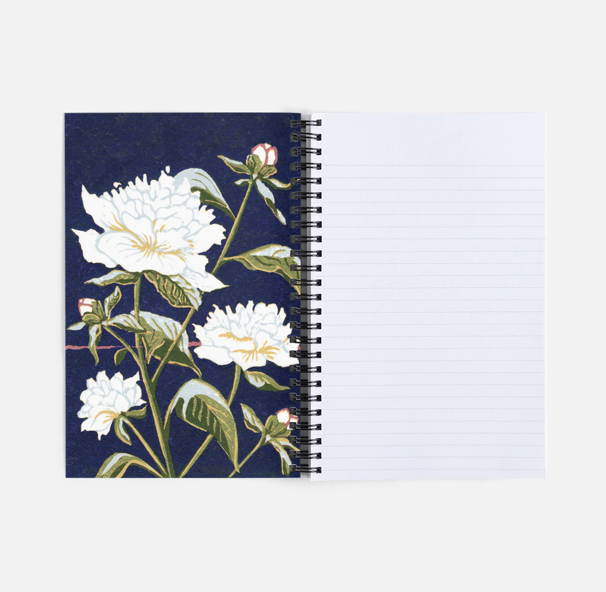 An open spiral-bound notebook with a dark navy floral cover on the left and lined blank pages on the right.  Featuring a reproduction of a peony block print by Natalia Wohletz of Peninsula Prints.