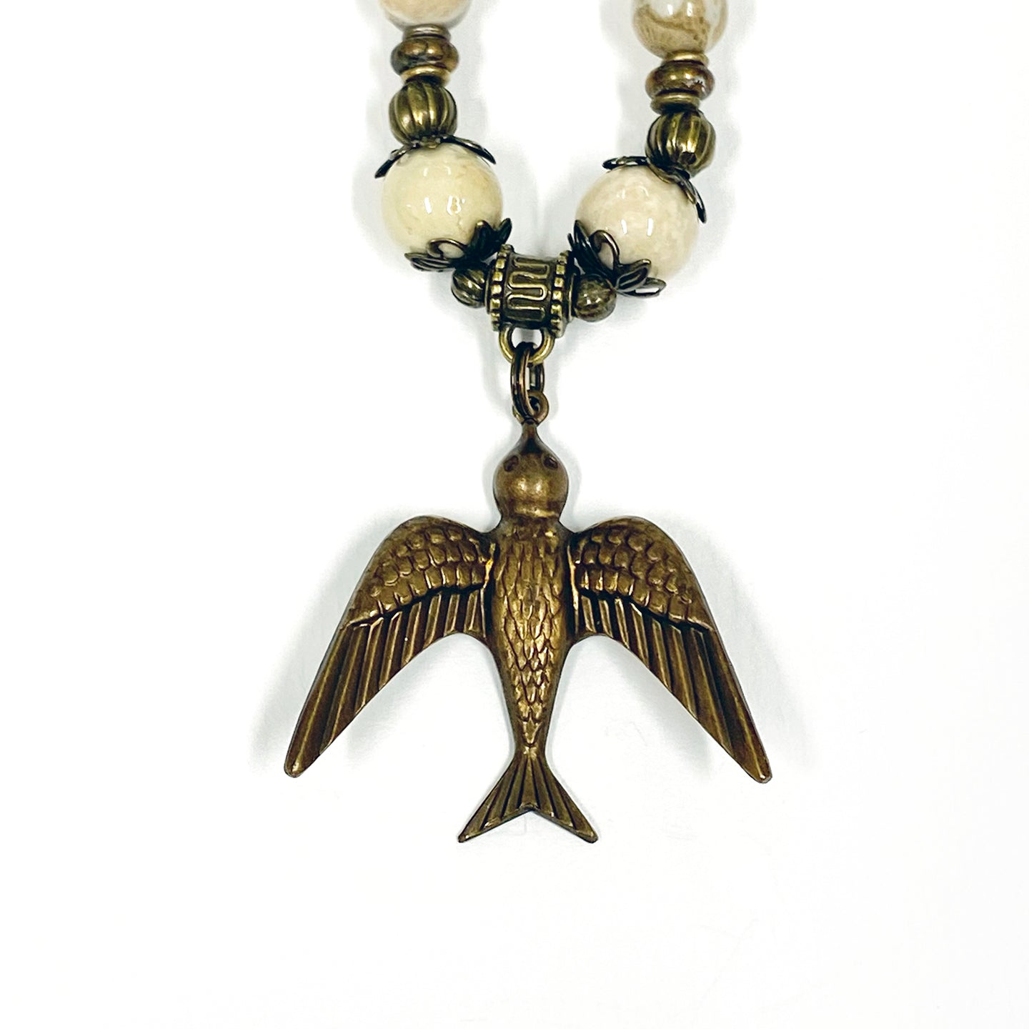 Petoskey Stone Necklace by Michigan artist Janice Copperstone featuring a hummingbird pendant.