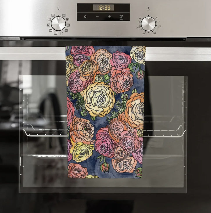 Ranunculus Towel by Abigail Leigh Designs. A floral patterned towel hanging on a kitchen oven door.