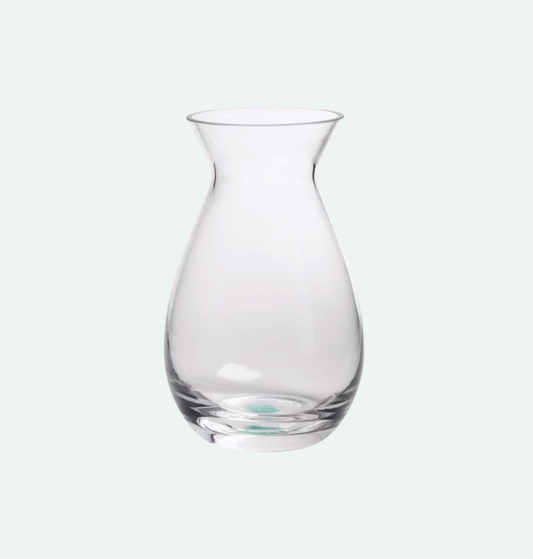 A clear glass bud vase with a bulbous body and a flared rim.