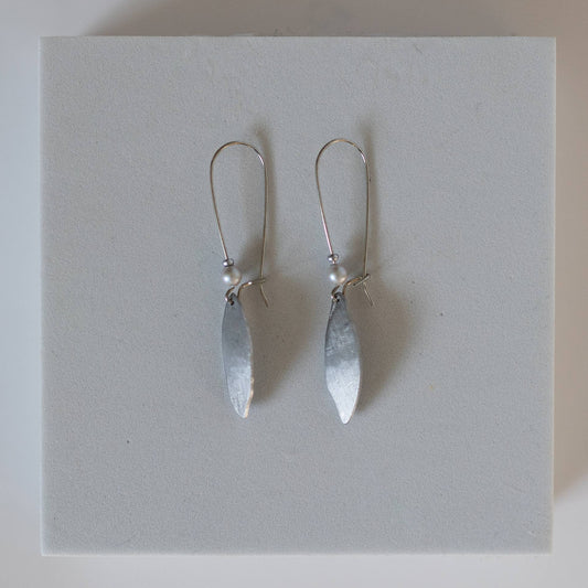 Earrings by Mend on the Move.Jewelry created from auto parts by abuse survivors in Detroit, Michigan.