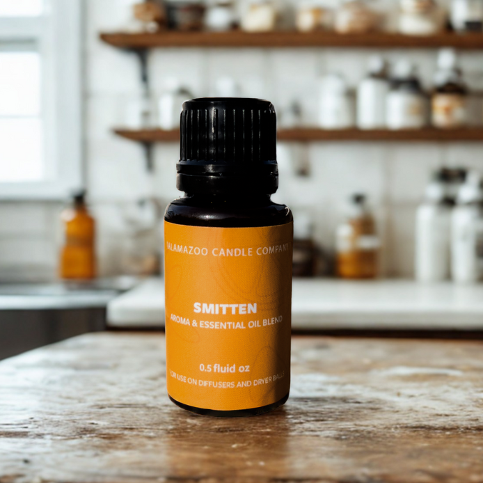 A 0.5 fluid oz bottle of Kalamazoo Candle Company 'Smitten' essential oil blend.