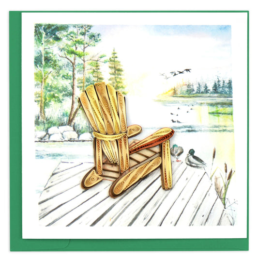 A quilled greeting card featuring a wooden Adirondack chair on a dock with a lake and ducks in the background.