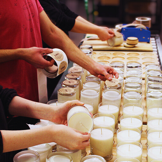 People working with candles on a production line at Kalamazoo Candle Co.