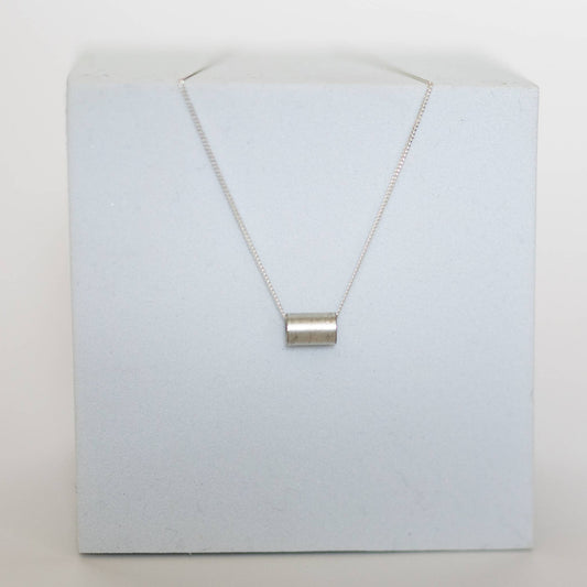 Necklace by Mend on the Move.Jewelry created from auto parts by abuse survivors in Detroit, Michigan.