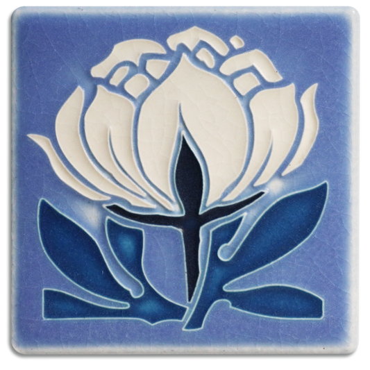 A handmade ceramic art tile featuring a blue peony bloom design by Motawi in Ann Arbor, Michigan.