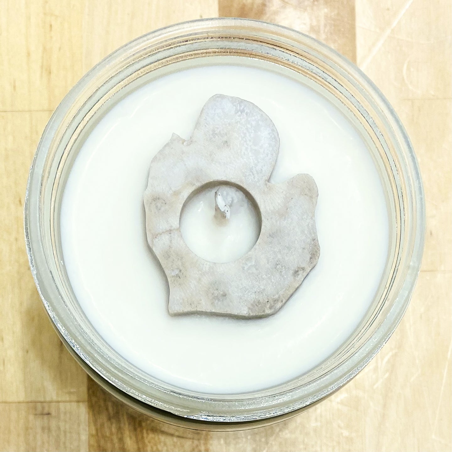 Soy wax candle with Petoskey Stone in the shape of the Michigan mittenby Ava's Illuminations handmade in northern Michigan. 
