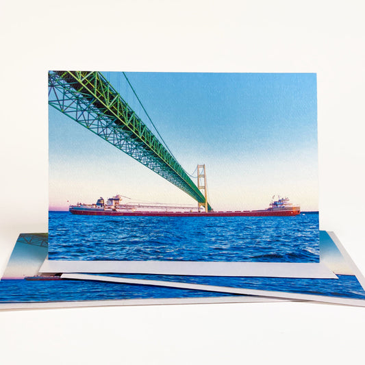 Blank greeting card featuring a photograph of a freighter passing under the Mackinac Bridge by local artist Jennifer Wohletz of Mackinac Memories.