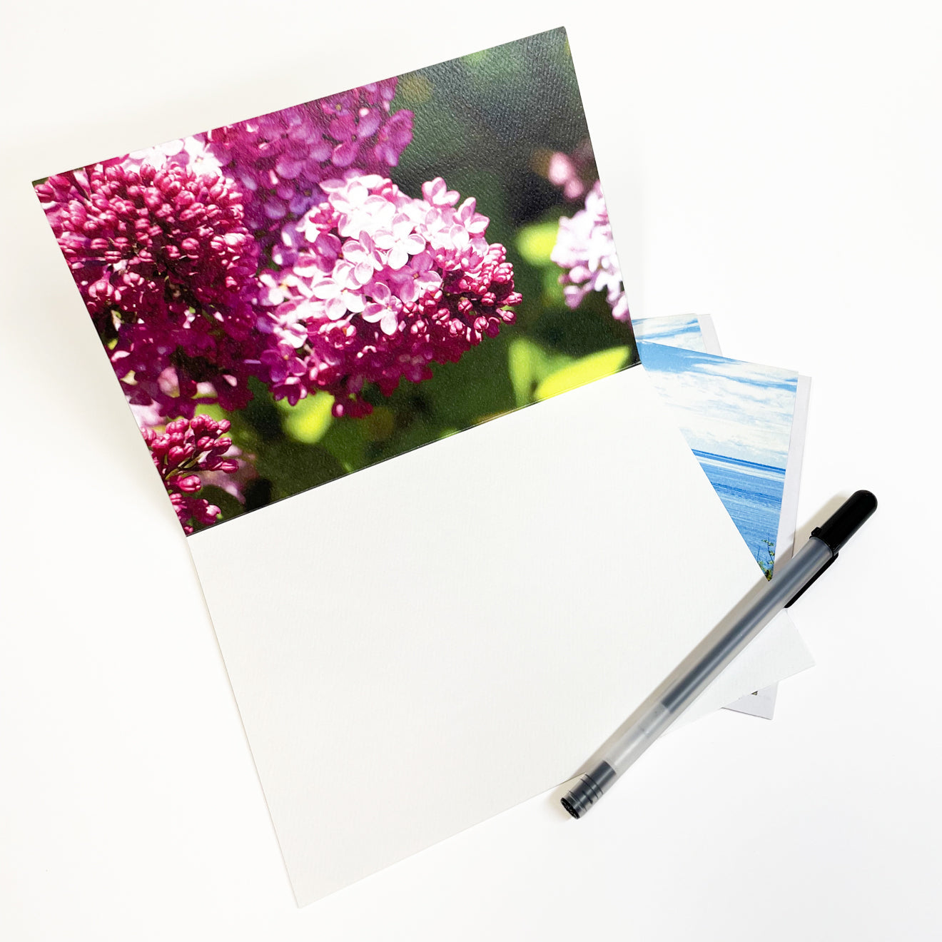 Blank greeting card featuring a photograph of lilacs blooming on Mackinac Island's West Bluff with a view of Round Island Lighthouse by local artist Jennifer Wohletz of Mackinac Memories. 